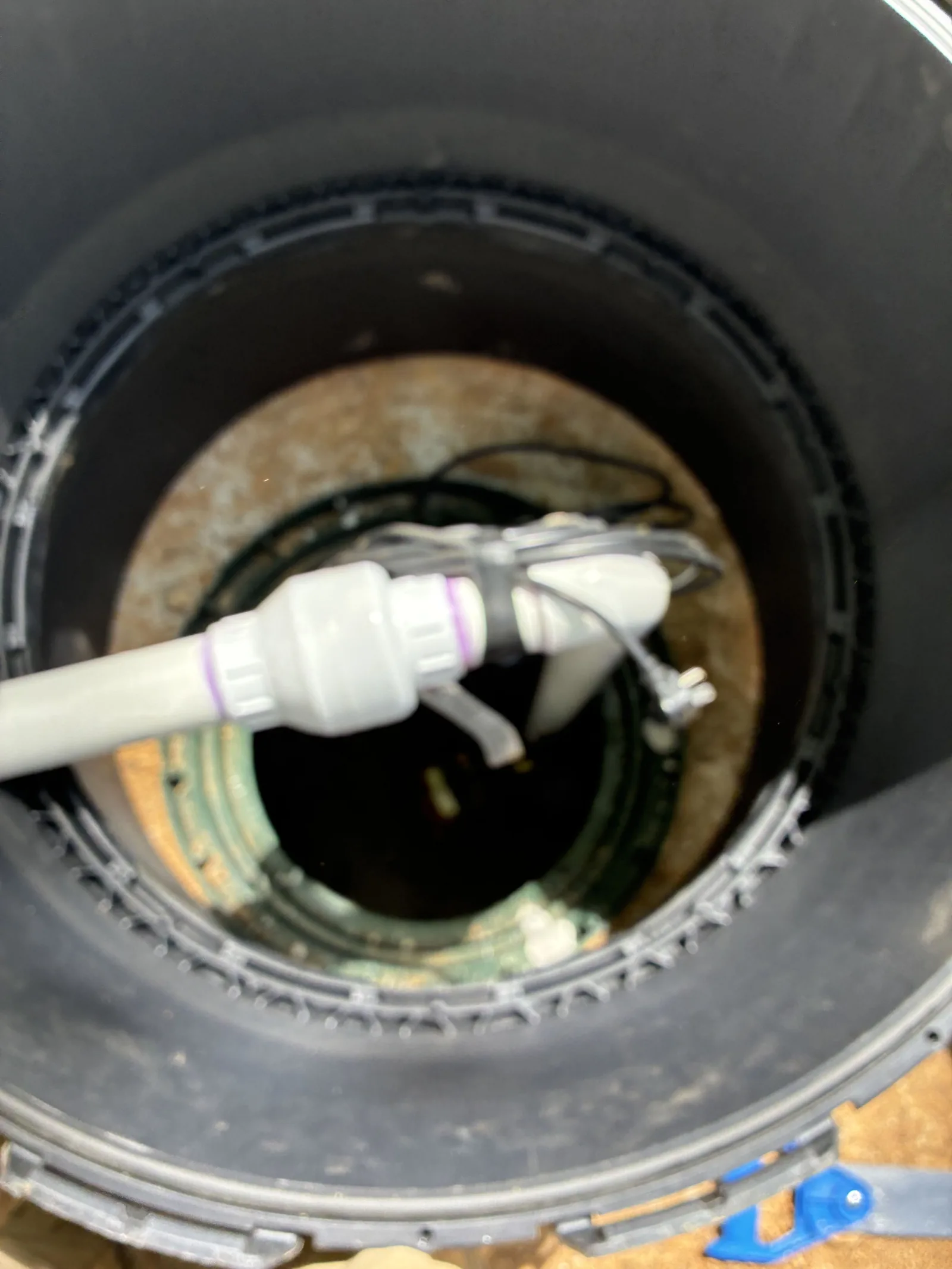 Pump discharge fitting inside a septic tank riser