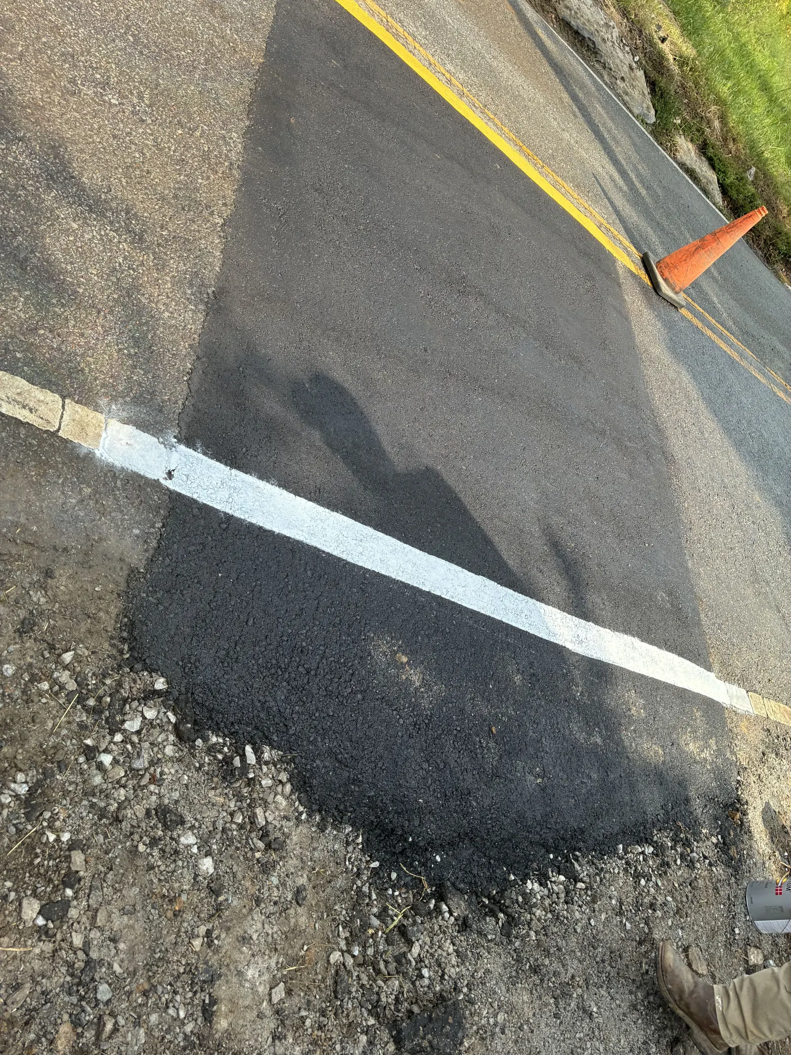 Finished asphalt patch and stripe after a sewer line road crossing