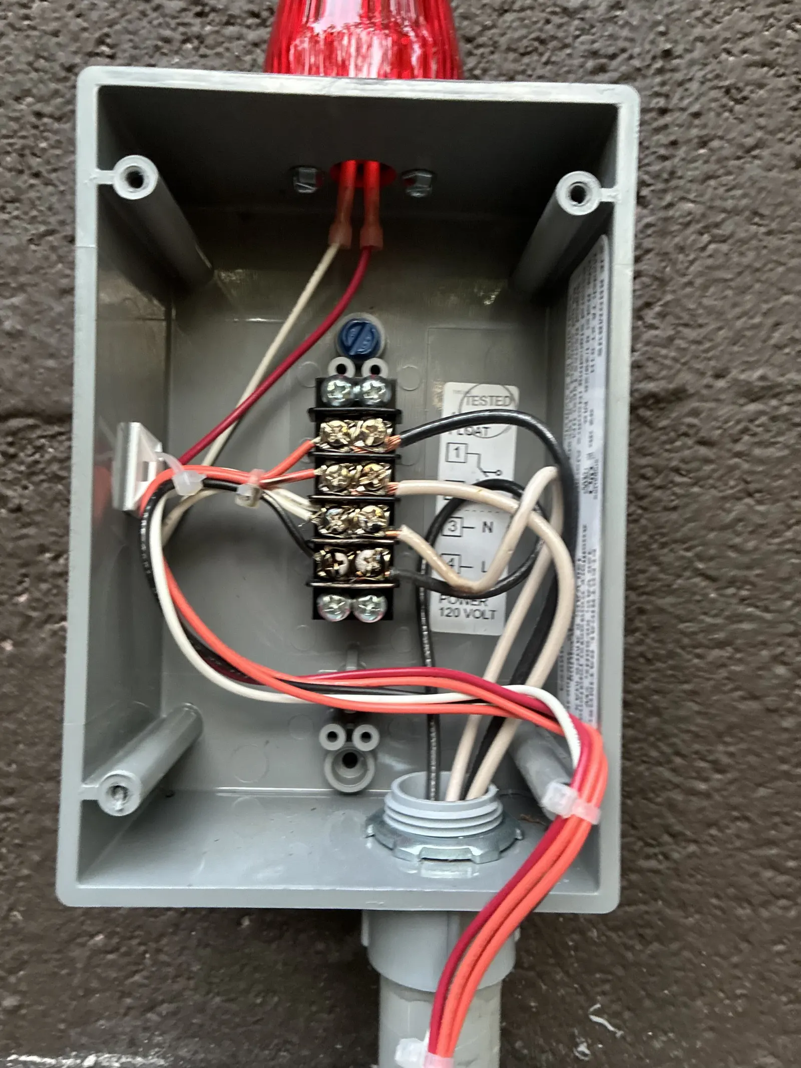 Wired septic control panel mounted on an exterior wall